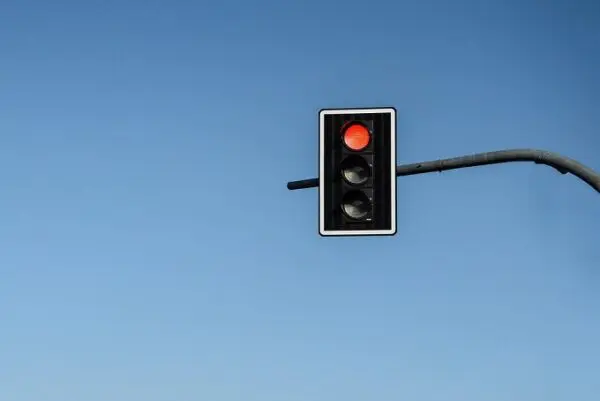 Rood stoplicht tegen een achtergrond van een blauwe lucht