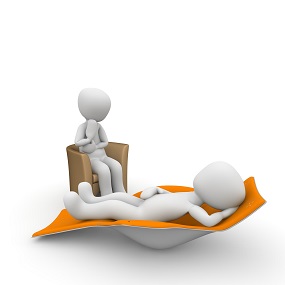 2 poppetjes; een in een stoel en een liggend op een bed.