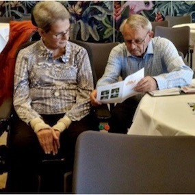 Twee personen lezen een flyer.