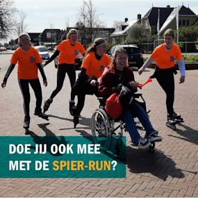 Vier personen skeeleren met persoon in rolstoel